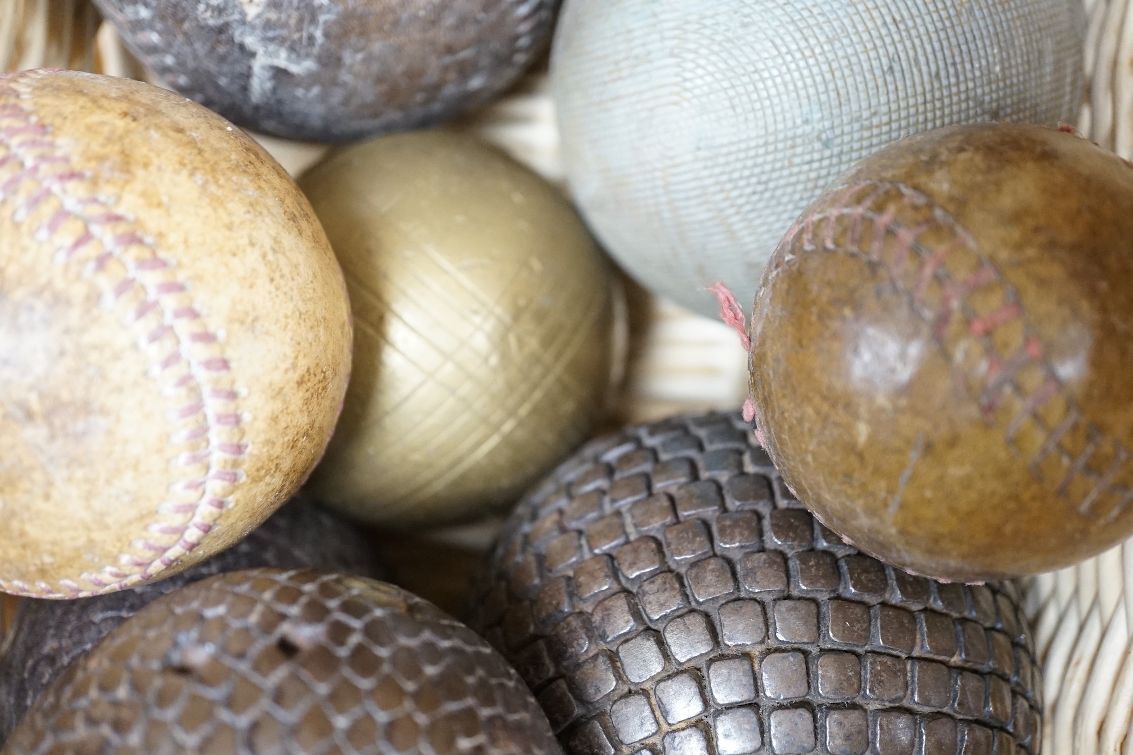 A collection of leather cricket and sporting balls